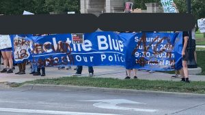 Omaha protestors pictured with stolen and modified "Back The Blue" banner during George Floyd Uprising