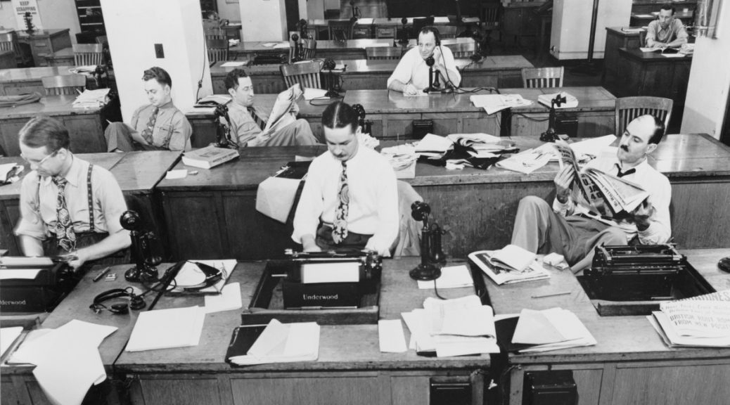 a buncha white NYT reporters in the news room in the 1930's