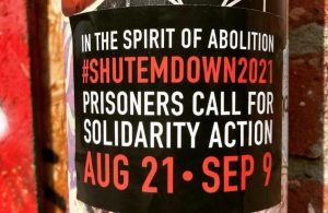 A sticker announcing "In The Spirit of Abolition | #SHUTEMDOWN2021 | Prisoners Call For Solidarity Action | Aug 21-Sep 9"