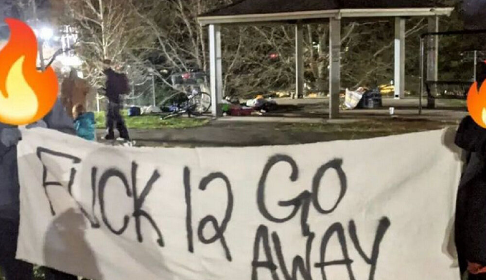 Picture of banner reading "Fuck 12 Go Away" in Aston Park in Asheville from the anti-encampment sweep protests. Photo by https://www.instagram.com/avl_solidaritynet/